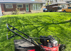 Lawn mower on a freshly cut green lawn